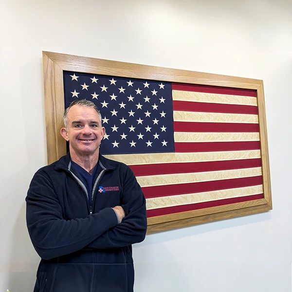 Image of smiling doctor in front of american flag